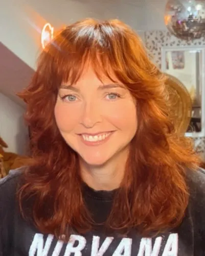 Bright copper shag with a curtain fringe and layered waves, front view