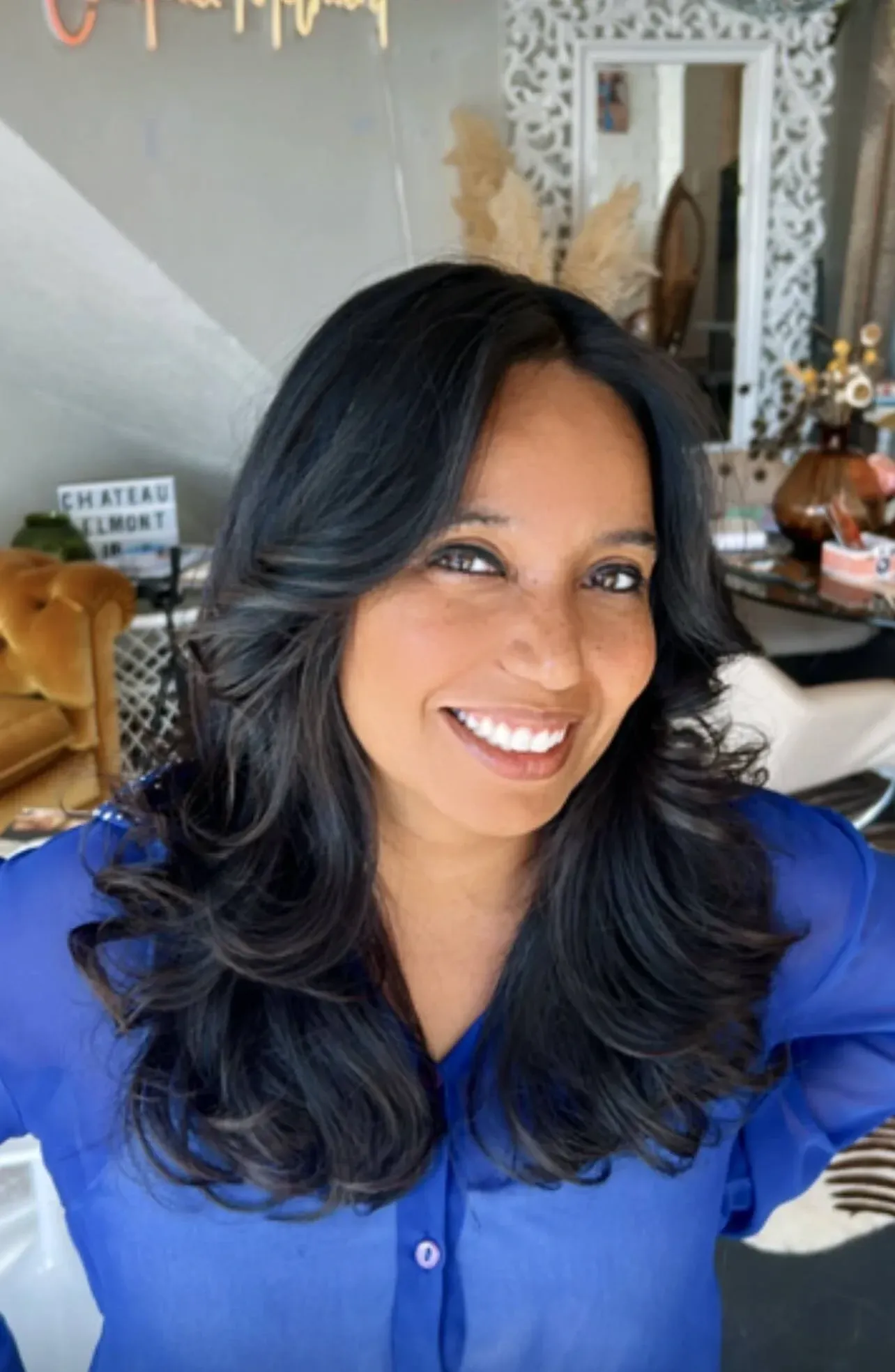 Glossy black blow-out with big, bouncy volume and curled ends