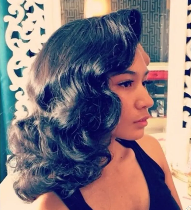 Side profile of glossy black Hollywood waves sculpted into deep S-shaped curls