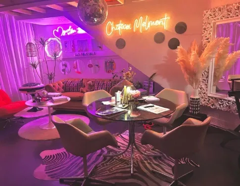 The studio lounge lit in pink and orange neon